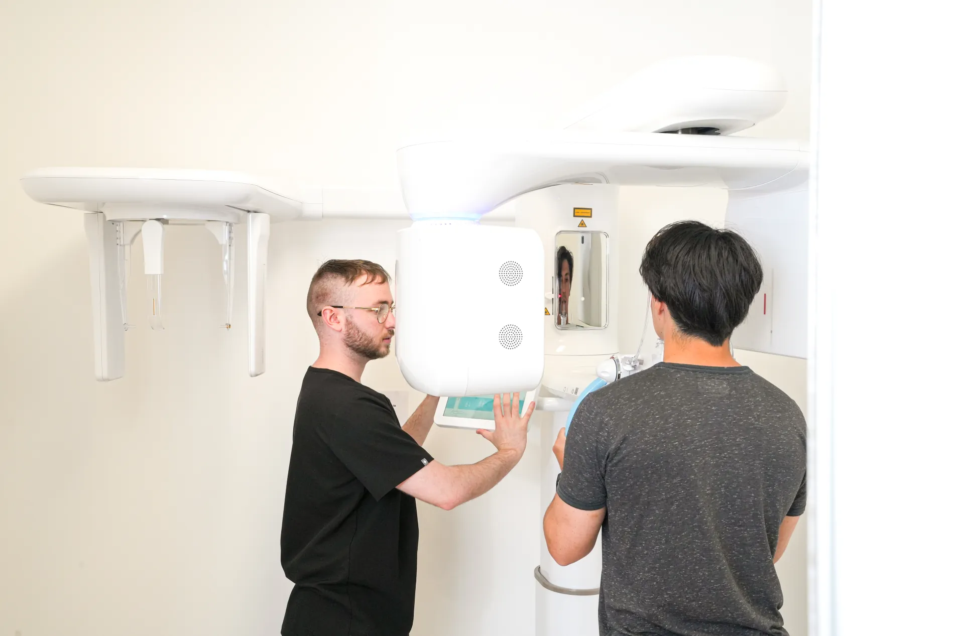 Clinicians positioning a patient at the practice's 3D imaging unit