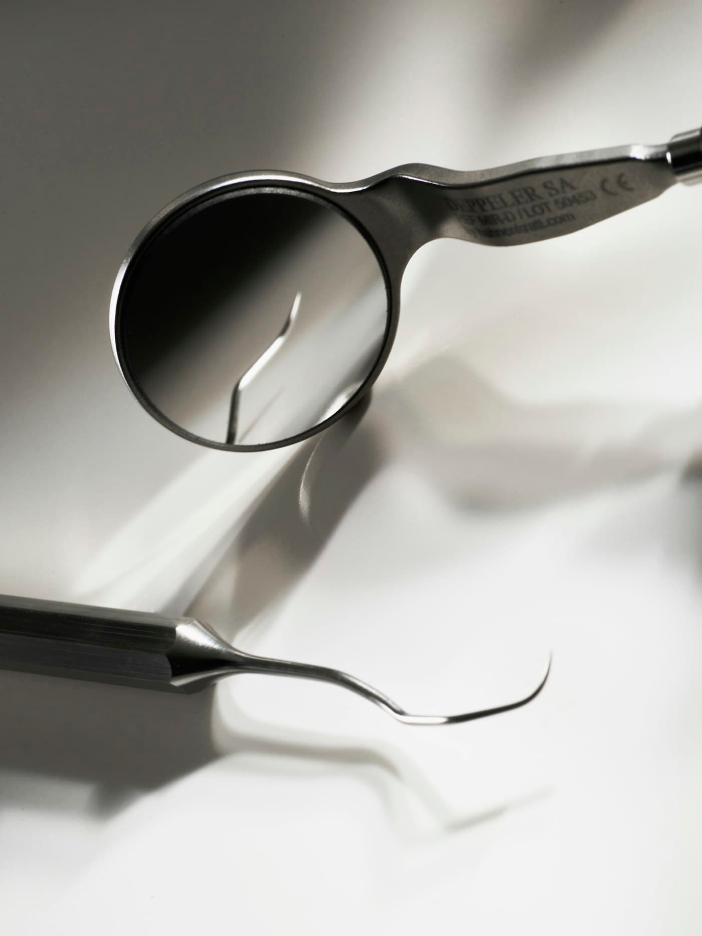 Dental mirror and instrument on a clean surface
